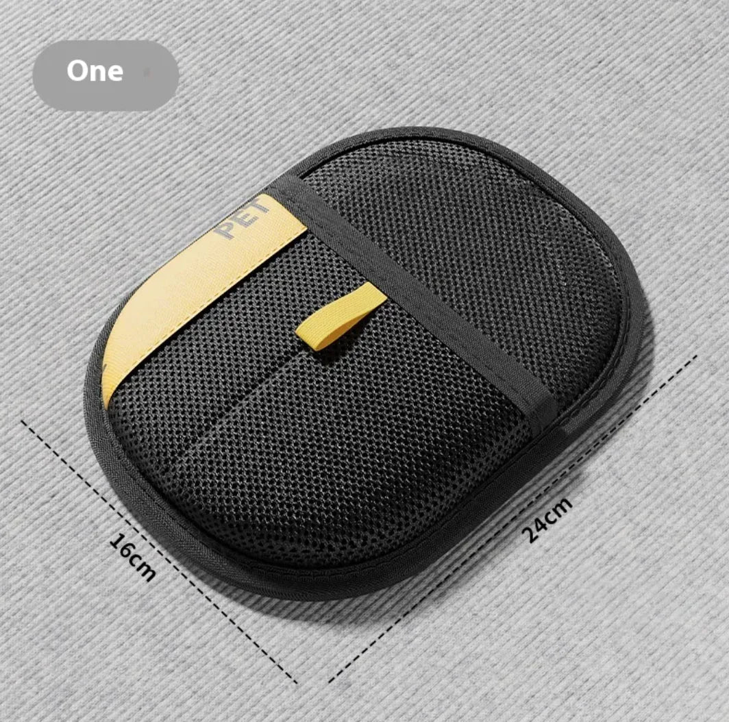 Black pet hair cleaner pouch with gold accent on a gray background